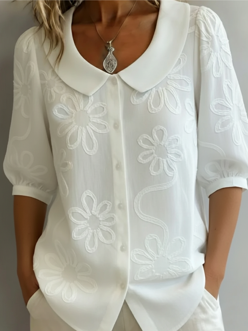 Women's blouse with embroidered floral pattern