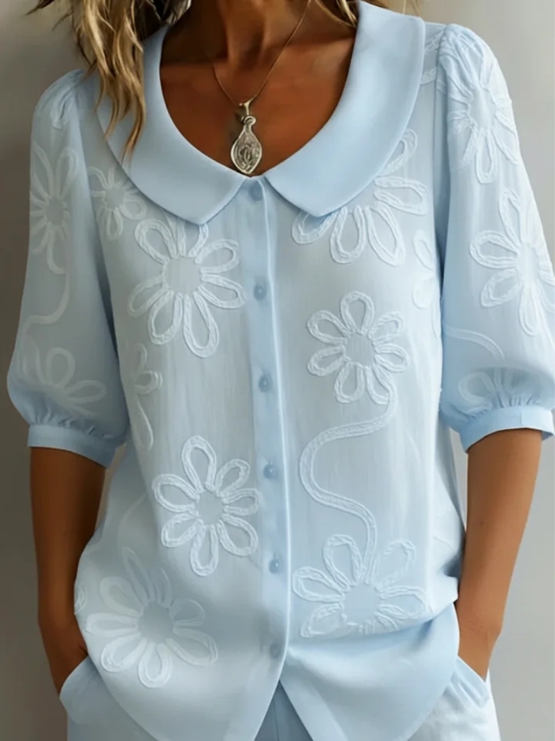 Women's blouse with embroidered floral pattern