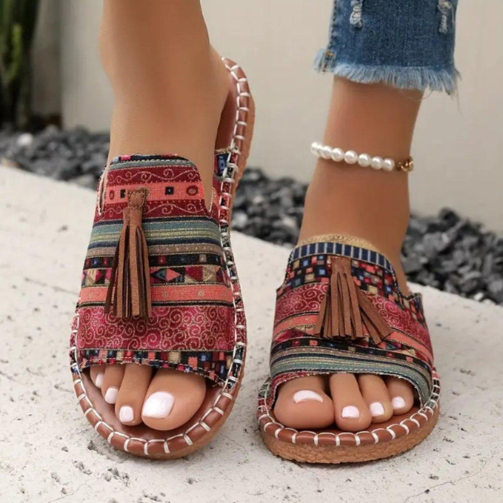 Women's flat slide sandals with open toe and tassel detail