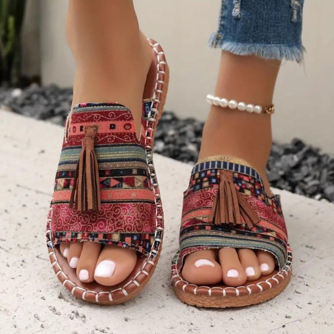 Women's flat slide sandals with open toe and tassel detail