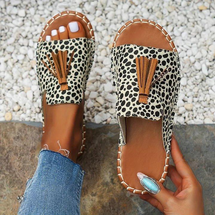 Women's flat slide sandals with open toe and tassel detail