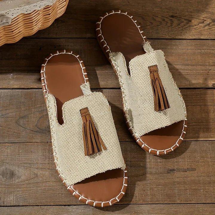 Women's flat slide sandals with open toe and tassel detail