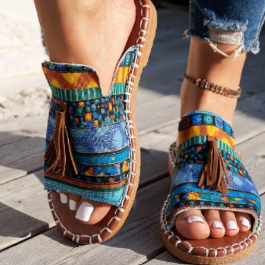 Women's flat slide sandals with open toe and tassel detail