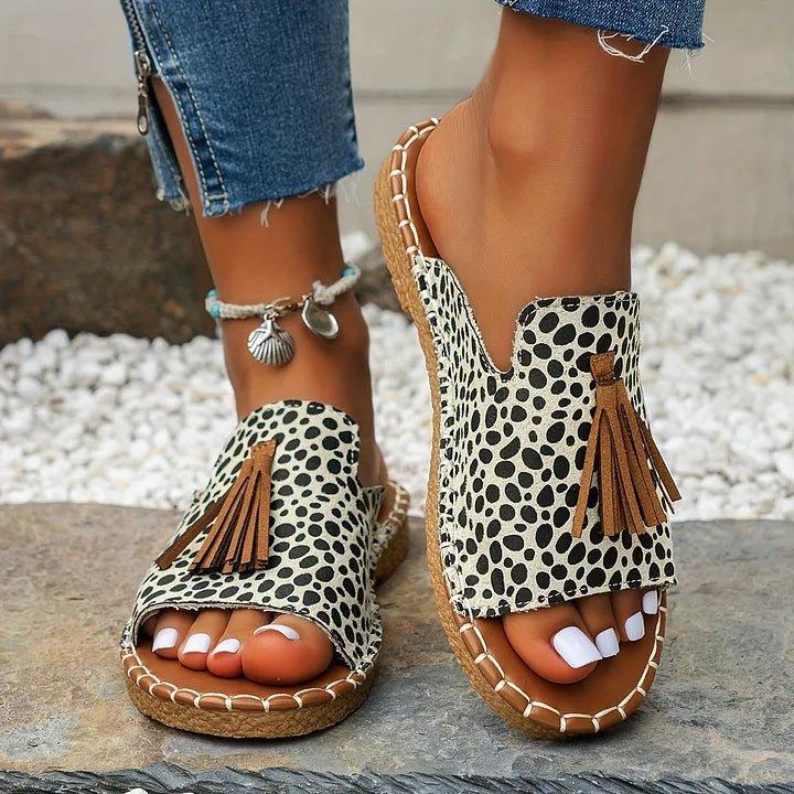 Women's flat slide sandals with open toe and tassel detail