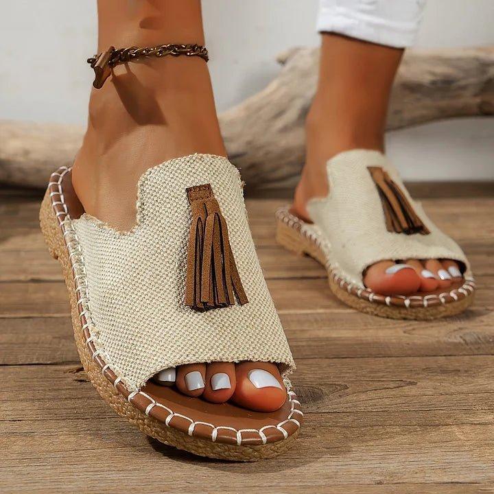 Women's flat slide sandals with open toe and tassel detail