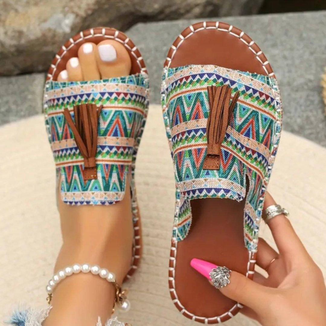 Women's flat slide sandals with open toe and tassel detail