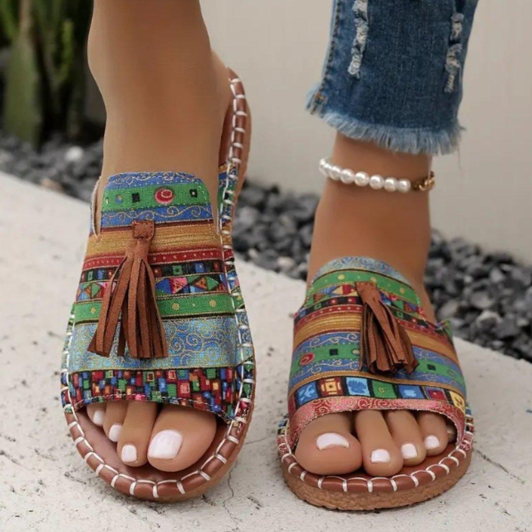 Women's flat slide sandals with open toe and tassel detail
