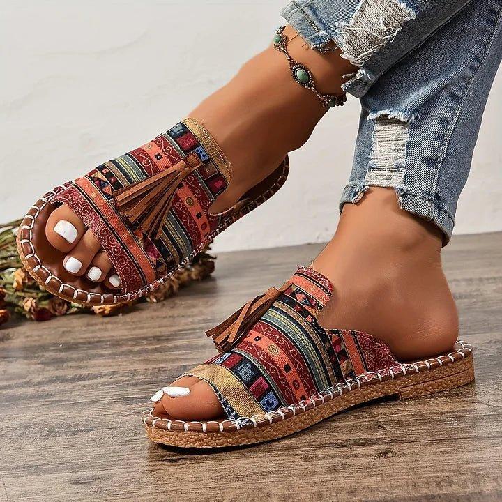 Women's flat slide sandals with open toe and tassel detail