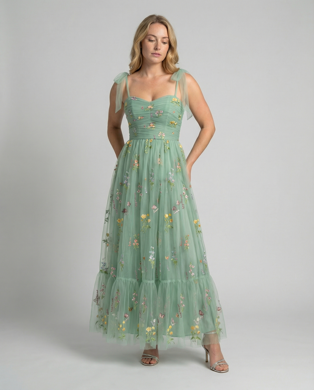 Women's floor-length ball gown with tulle skirt and structured bodice