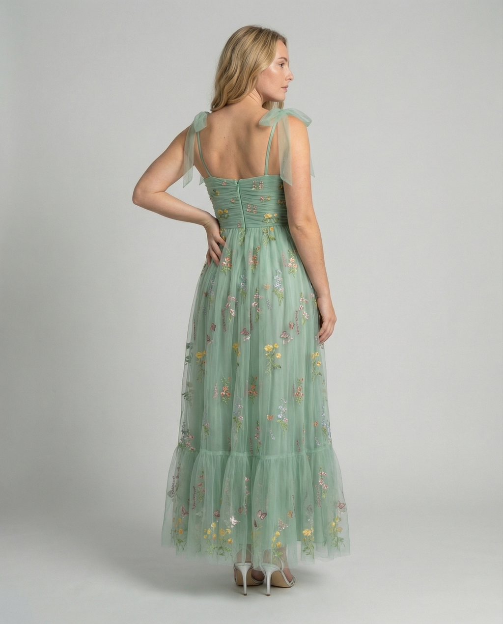 Women's floor-length ball gown with tulle skirt and structured bodice