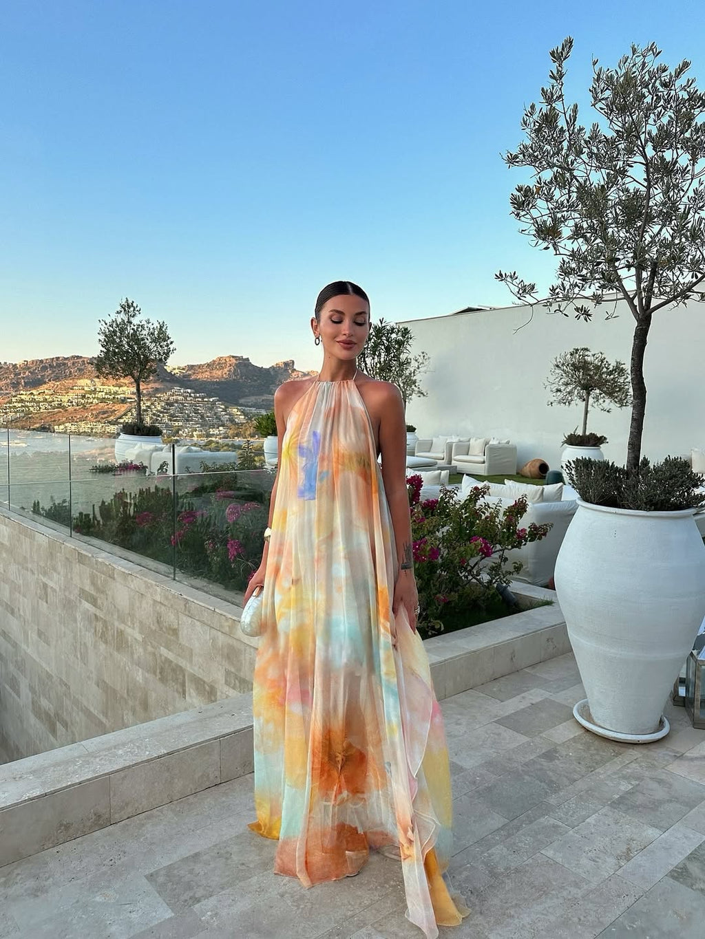 Women's halter-neck maxi dress with floral print and flowy skirt
